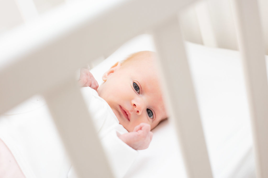 baby in a cot in Godalming home