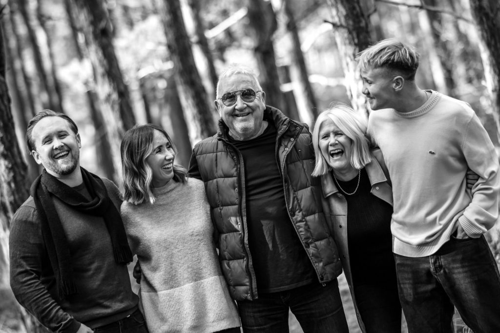 family photographed laughing in Godalming