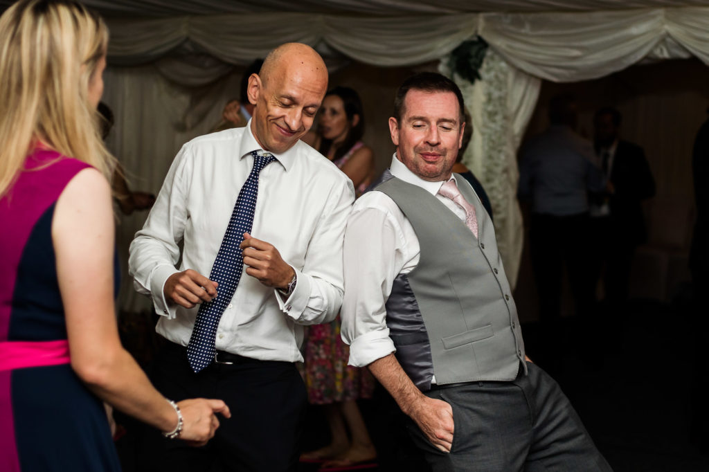 men dancing at a Surrey wedding